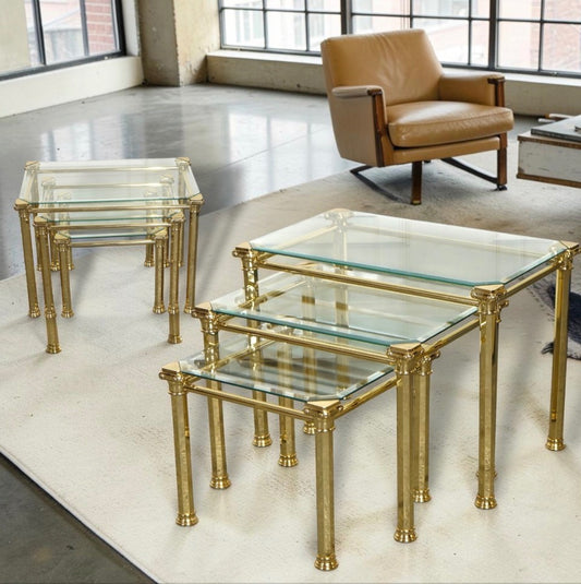 A pair of 1970s Maison Jansen style brass and glass nesting tables