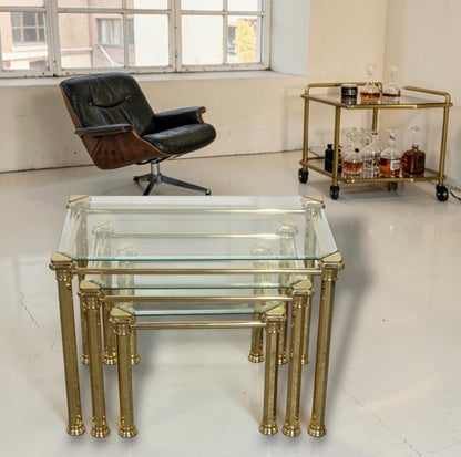 A nest of  three 1970s Maison Jansen style brass and glass tables.